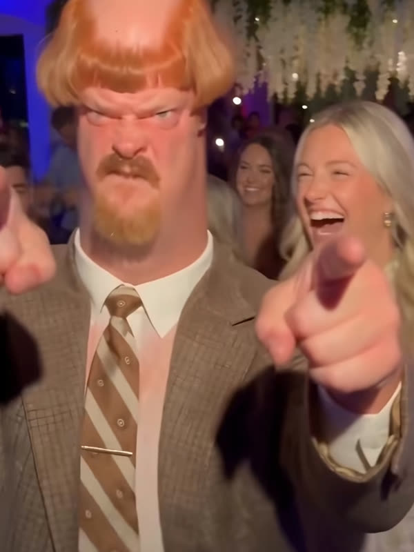 AI character Harold pointing at the camera at a party