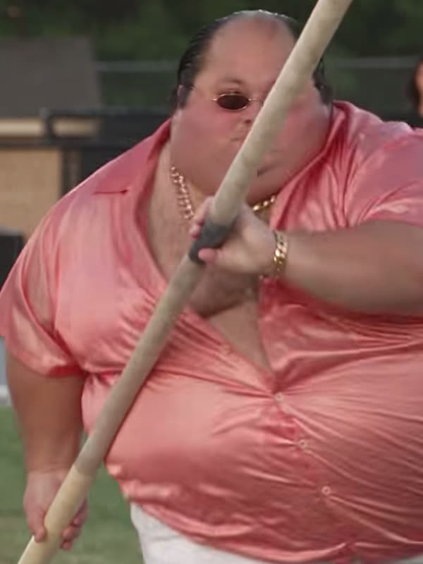 AI character in a pink satin shirt holding a pole